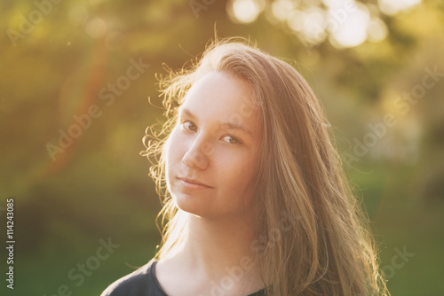 pretty teen girl smiling in warm sunset