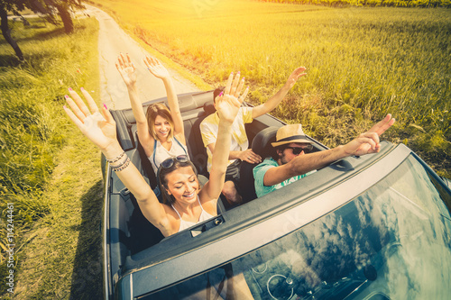 Group of people having fun at car trip around Europe photo