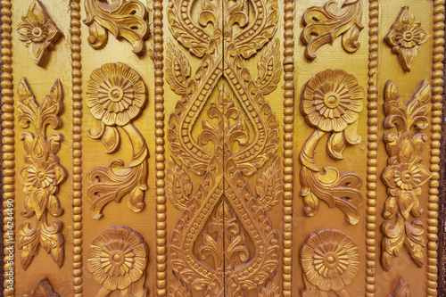 Wood carving on the wall in Myanmar. Myanmar carving on golden wall.