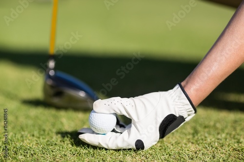 Cropped image of woman holding golf ball 