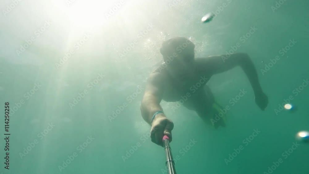 Male caucasian man swimmer diver swims under water in the sea. Summer tourism, travel journey trip voyage, holiday and vacation. Underwater survey selfie Slow motion 0.5x Male caucasian man swimmer diver swims under water in the sea. Summer tourism, travel journey trip voyage, holiday and vacation. Underwater survey selfie Slow motion 0.5x