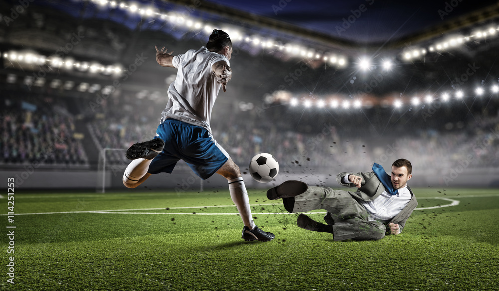 Fototapeta premium Businessman and player fighting for ball . Mixed media
