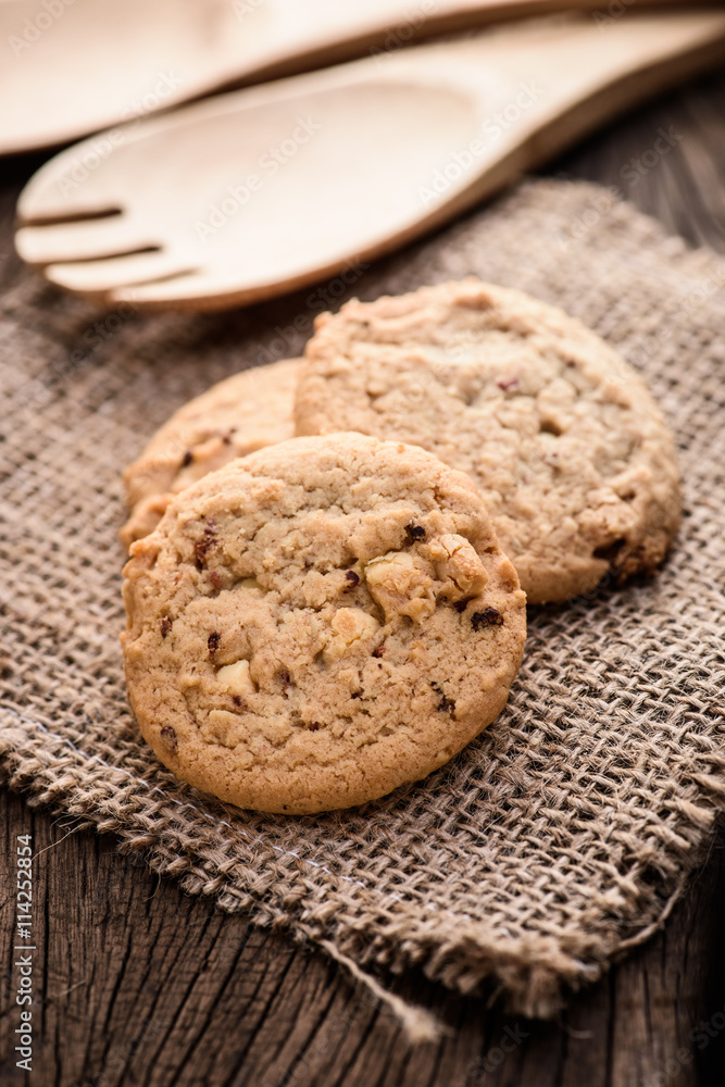 Chocolate cookies on white linen napkin on wooden table. Chocola Chocolate cookies on white linen napkin on wooden table. Chocola