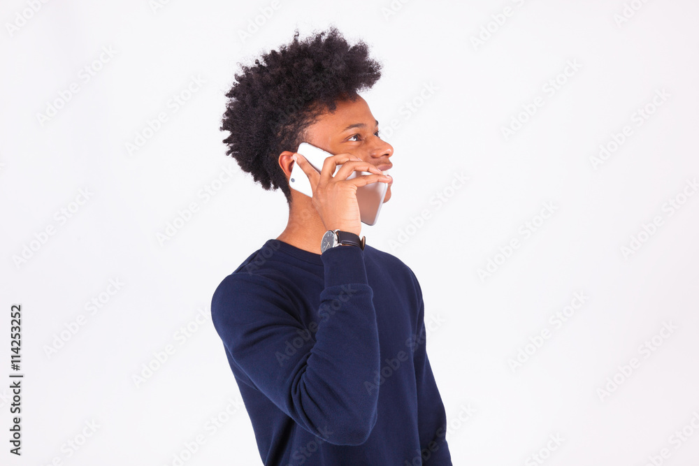 Young African American man making a phone call on her smartphone Young African American man making a phone call on her smartphone