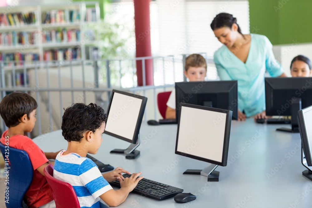 Children using computers as teacher teaching them Children using computers as teacher teaching them