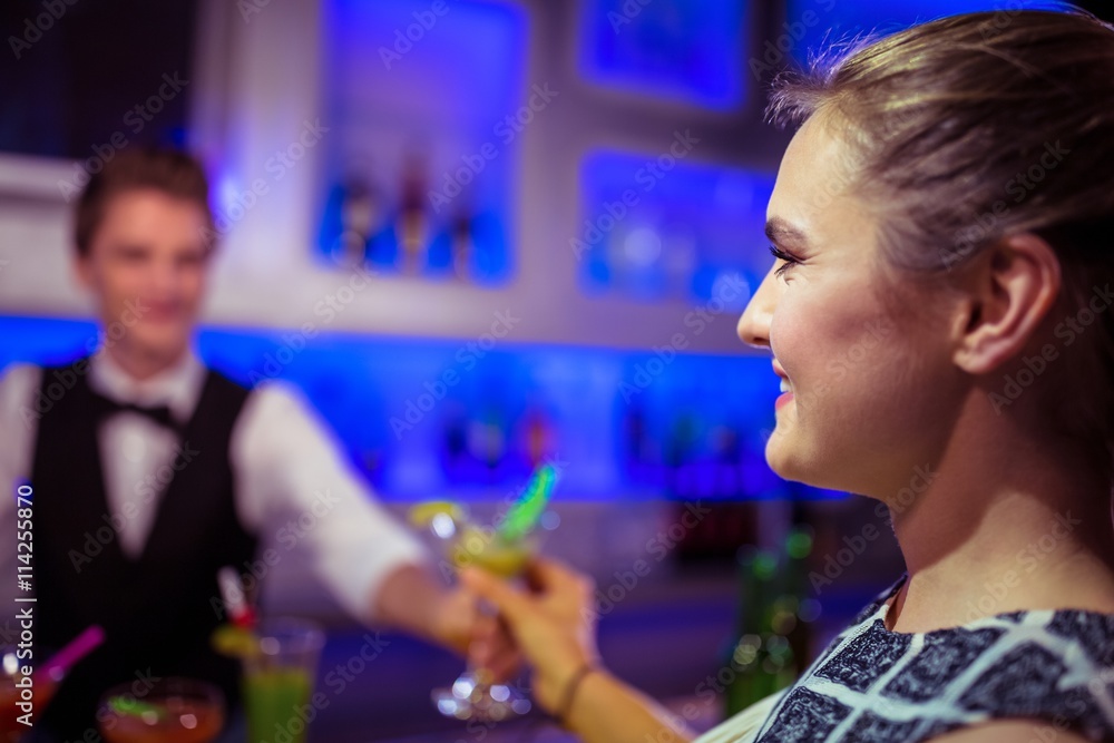 Barman serving cocktail to woman Barman serving cocktail to woman