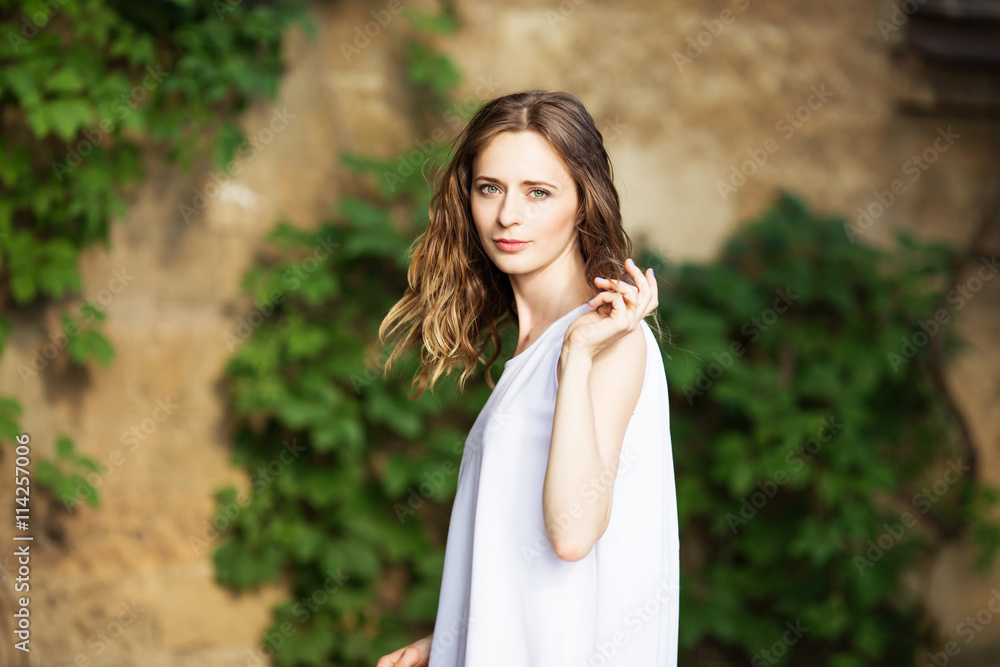 Portrait of lovely urban girl in short white dress in the street Portrait of lovely urban girl in short white dress in the street