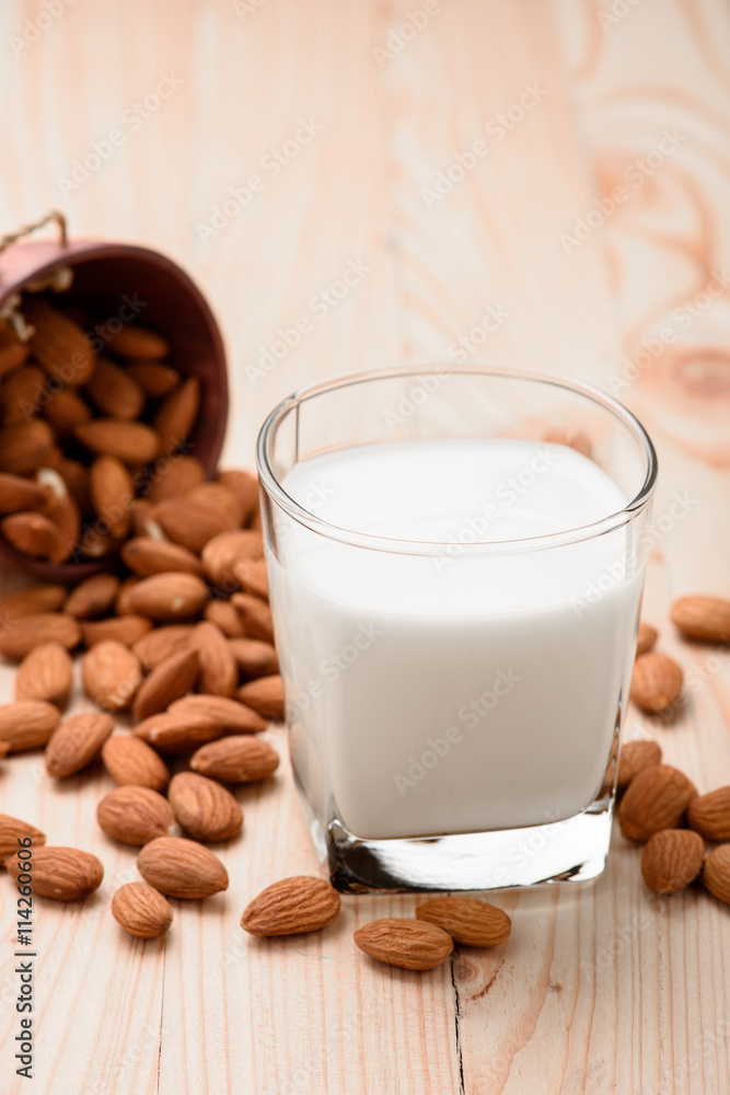 Almond milk in a glass with almonds Almond milk in a glass with almonds