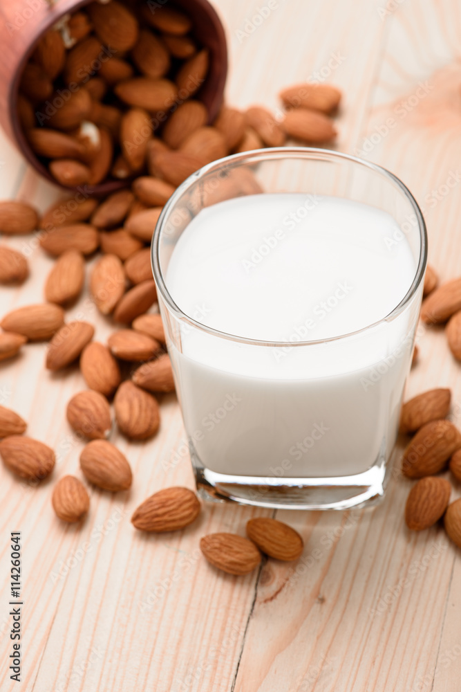 Almond milk in a glass with almonds Almond milk in a glass with almonds