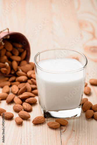 Almond milk in a glass with almonds