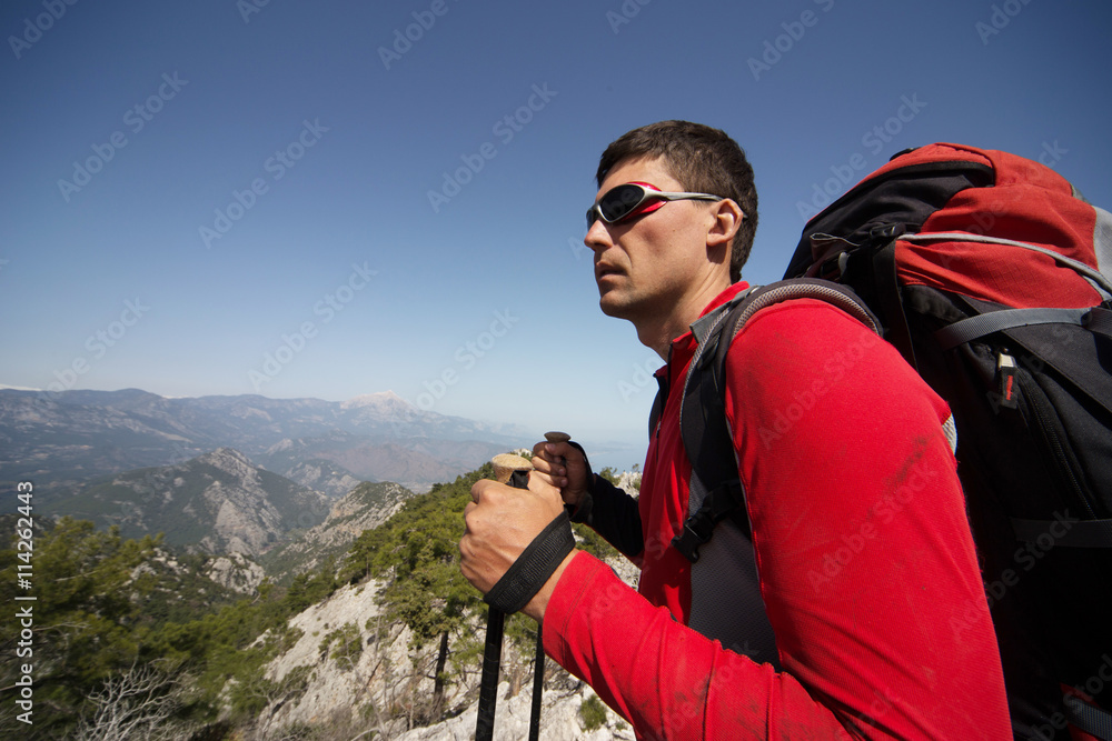 Man hiking in the mountains on a sunny day.