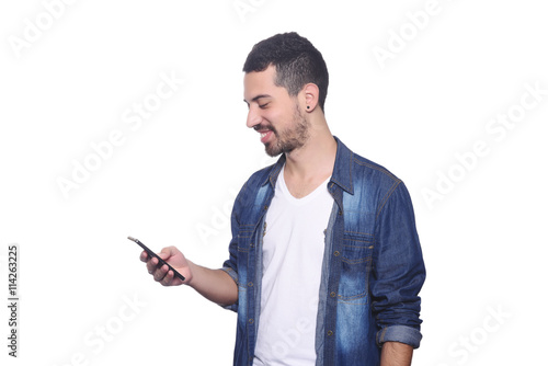 Young latin man typing on his smartphone.