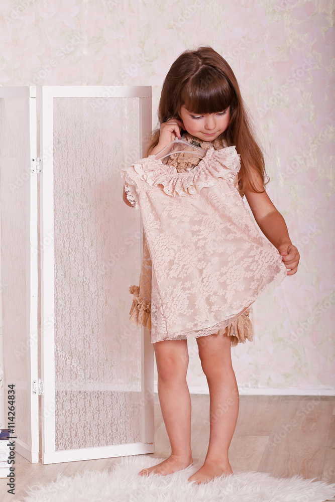 a little girl tries on a dress a little girl tries on a dress