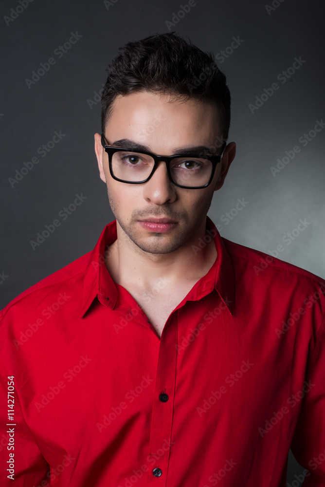 Man on black background in red shirt and glasses. Business style Man on black background in red shirt and glasses. Business style