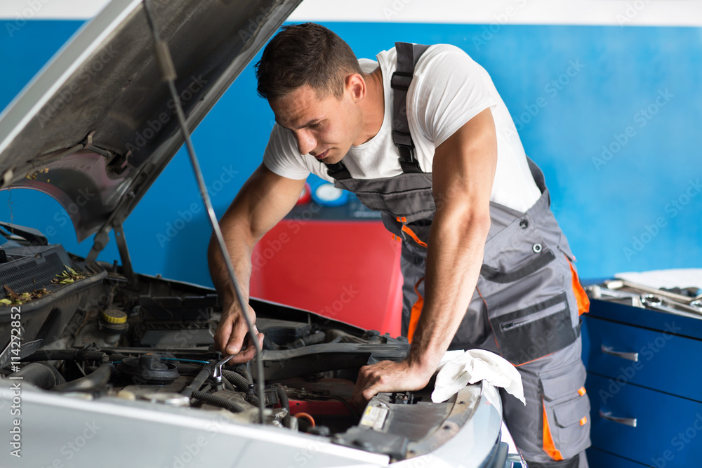 Attractive auto mechanic using a wrench Attractive auto mechanic using a wrench