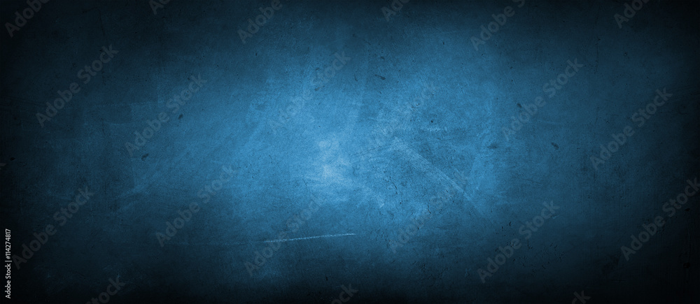 Blue textured concrete wall background. Dark edges Blue textured concrete wall background. Dark edges