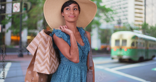 Photography Happy black woman shopping in San Francisco on city street