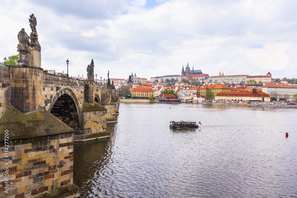 Vltava river and Charles Bridge at cloudy sky with Prague castle in the background, Prague, Czech Republic