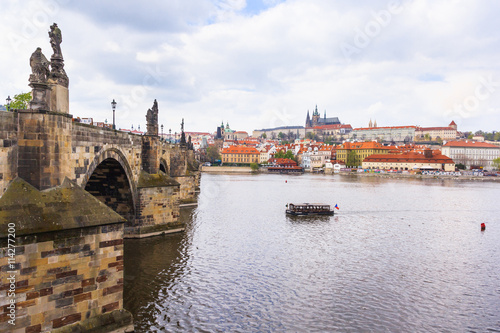 Vltava river and Charles Bridge at cloudy sky with Prague castle in the background, Prague, Czech Republic