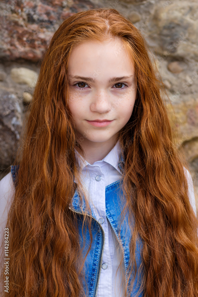 Portrait of beautiful smiling redhead with long hair girl with freckles Portrait of beautiful smiling redhead with long hair girl with freckles