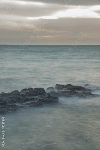 stones by the sea. waves of the sea from long exposure. © nuruddean