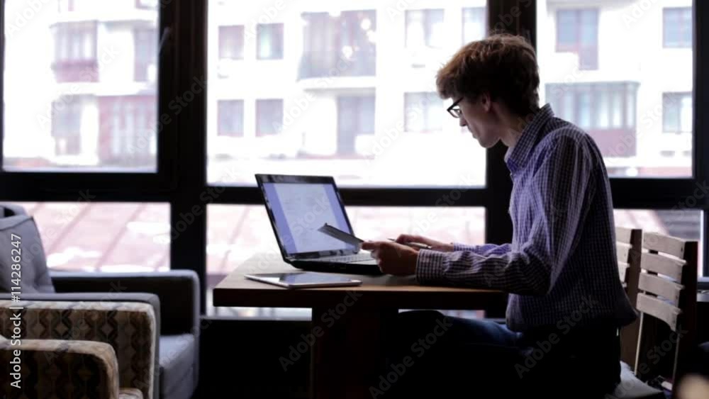 Man Checks Drawings Using a Laptop Man Checks Drawings Using a Laptop