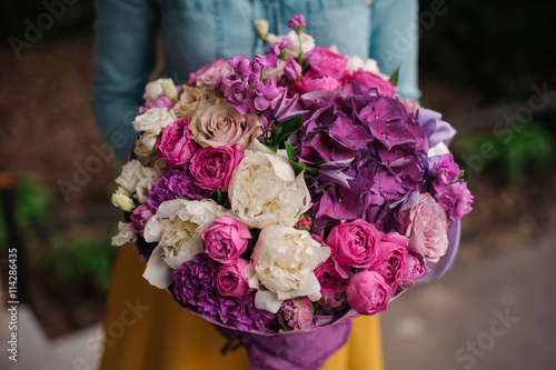 Wallpaper Mural girl holding a bouquet of purple and white flowers Torontodigital.ca