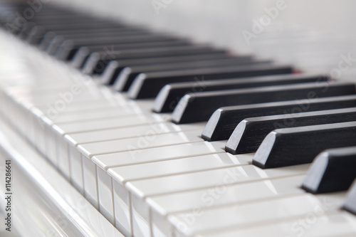 Piano keys on white piano.