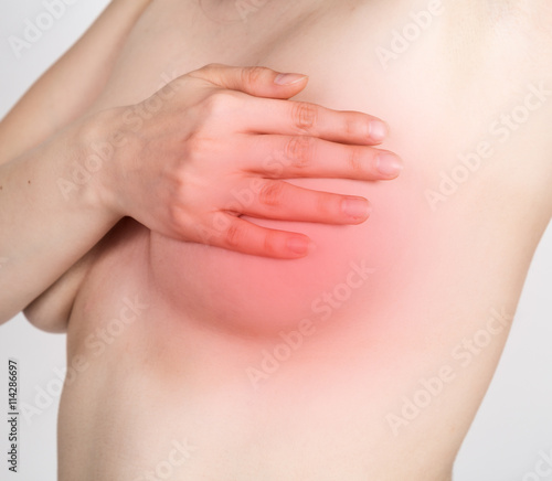 Breast cancer self check. Young woman examining her breast for lumps or signs of breast cancer. healthy lifestyle concept