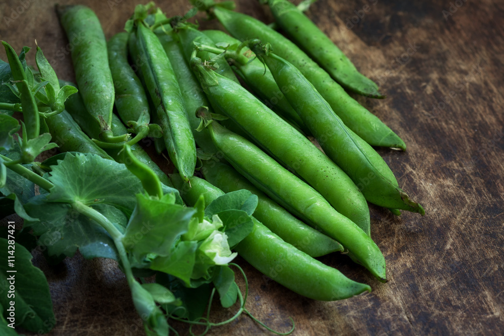Organic green peas on wooden table Organic green peas on wooden table