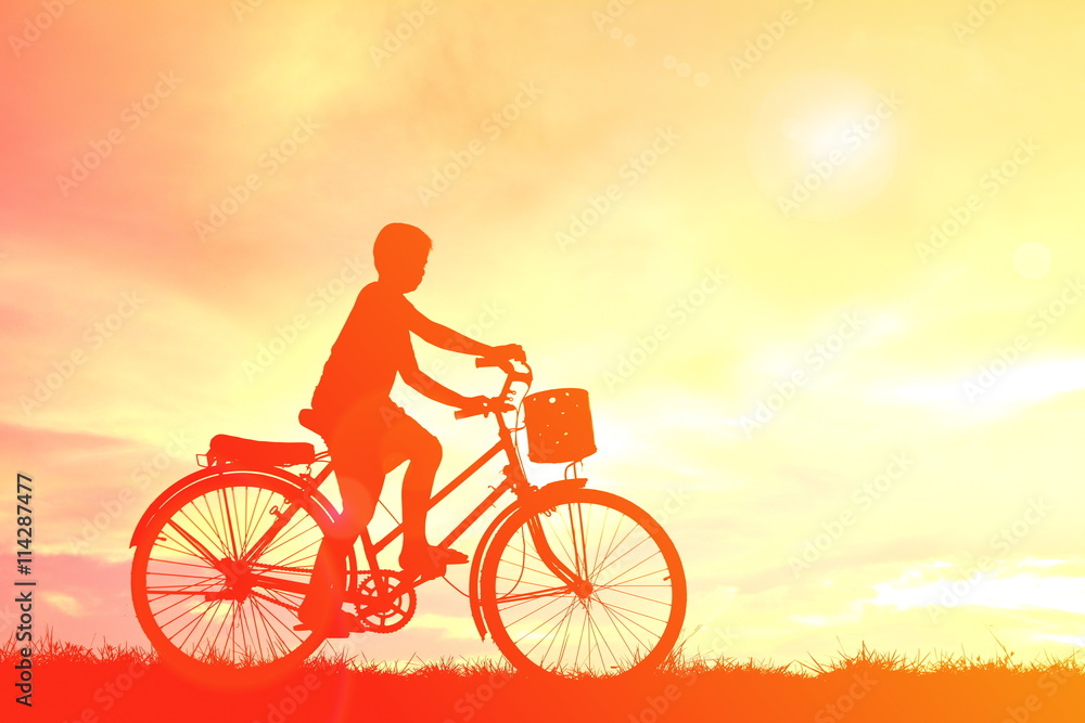 Silhouette children and bicycle at sunset Silhouette children and bicycle at sunset