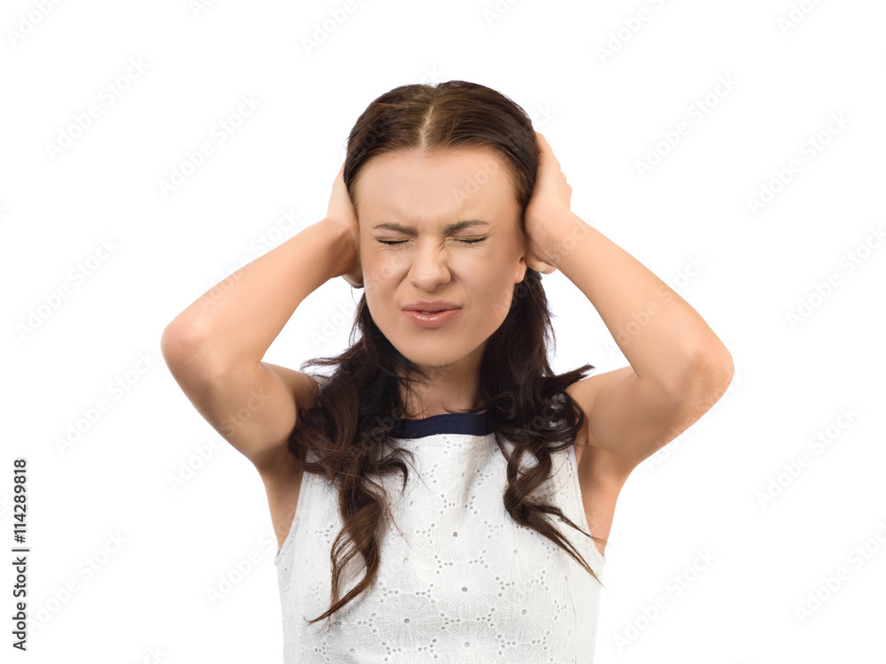 Young woman trying to block out a noise with her hands Young woman trying to block out a noise with her hands