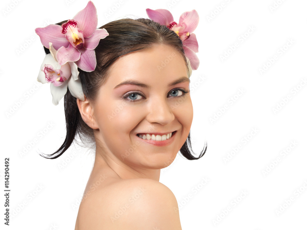 Naklejka premium Portrait of attractive woman with orchids in her hairstyle.