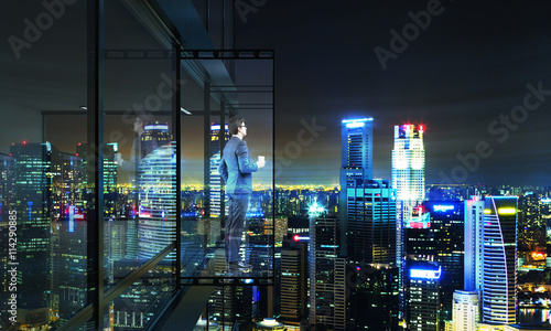 Man on balcony at nighttime