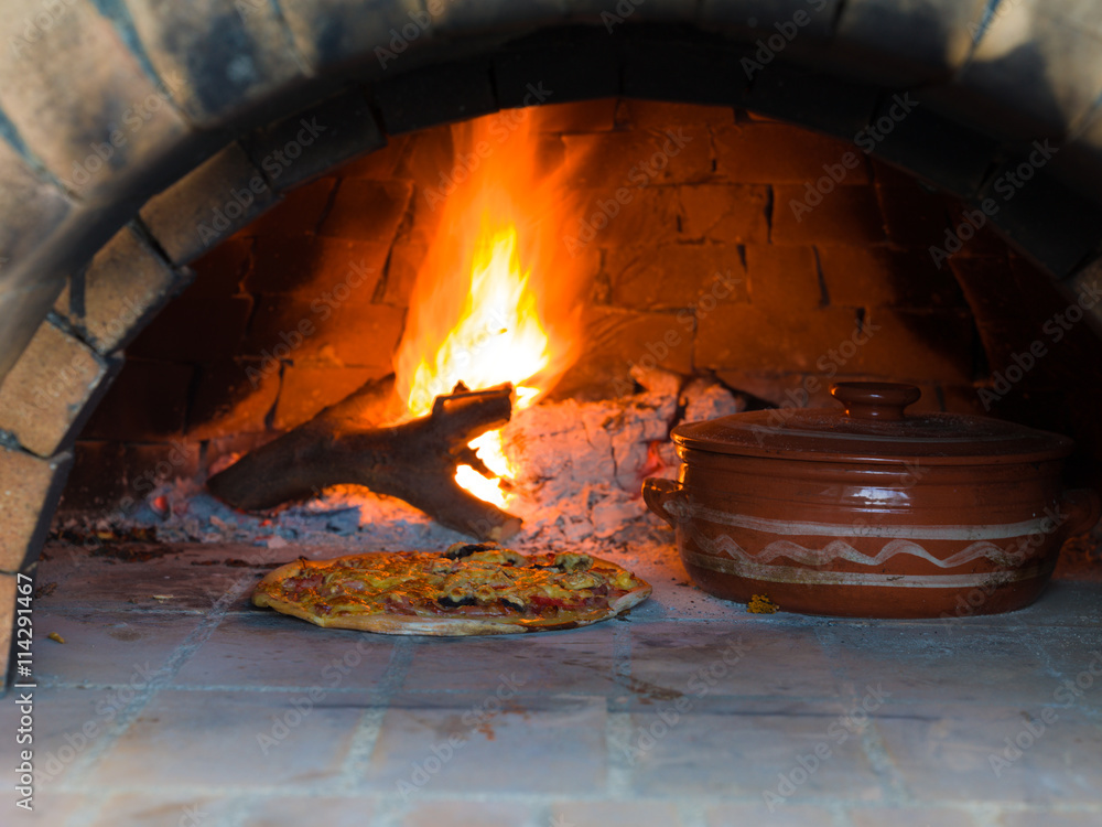 Pizza baking in a tradition wood oven