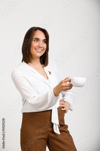 Portrait of young successful business woman over white backgroun