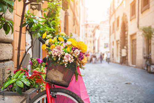 Bicycle with flowers in the old street in Rome, Italy