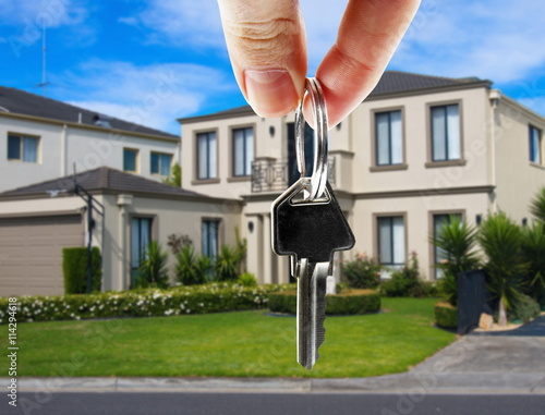 key in hand with real estate photo