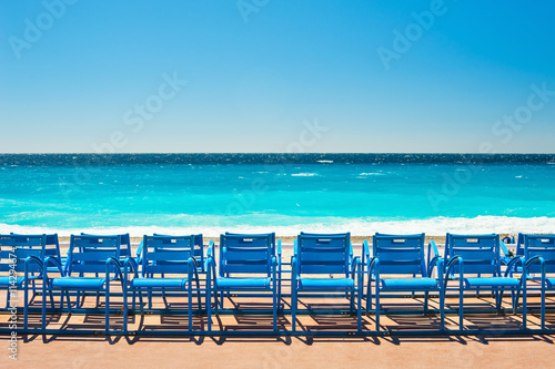 Blue chairs on the Promenade des Anglais in Nice, France photo