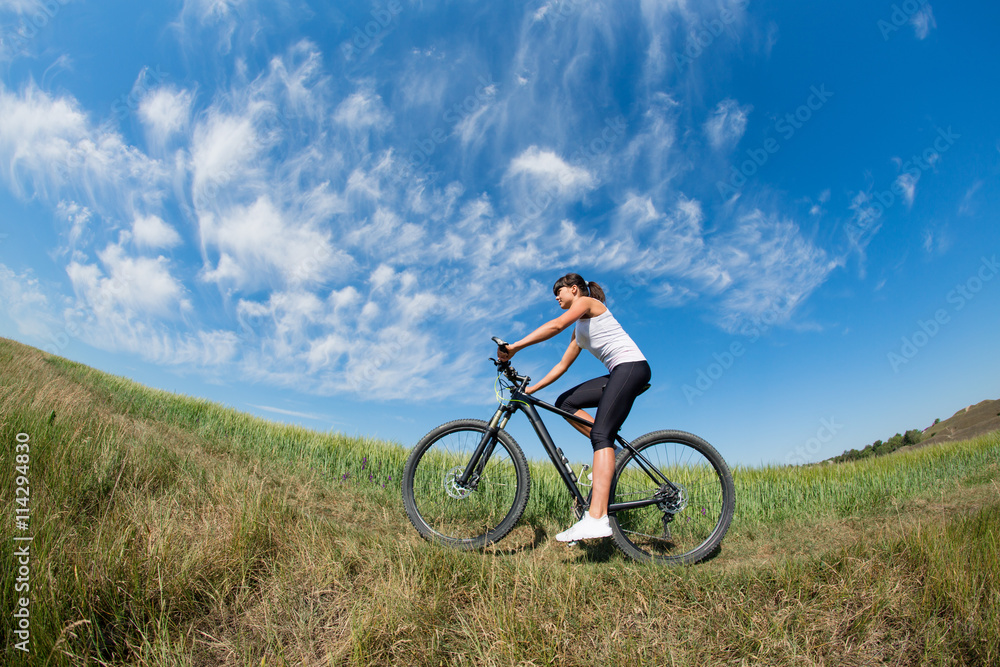 Sport bike woman on the meadow with a beautiful landscape Sport bike woman on the meadow with a beautiful landscape
