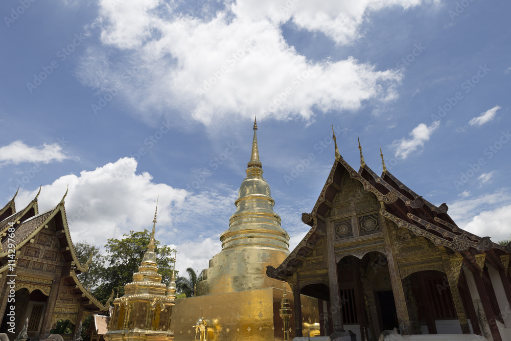 Naklejka premium golden pagoda and sanctuary in buddhism temple with leaves frame