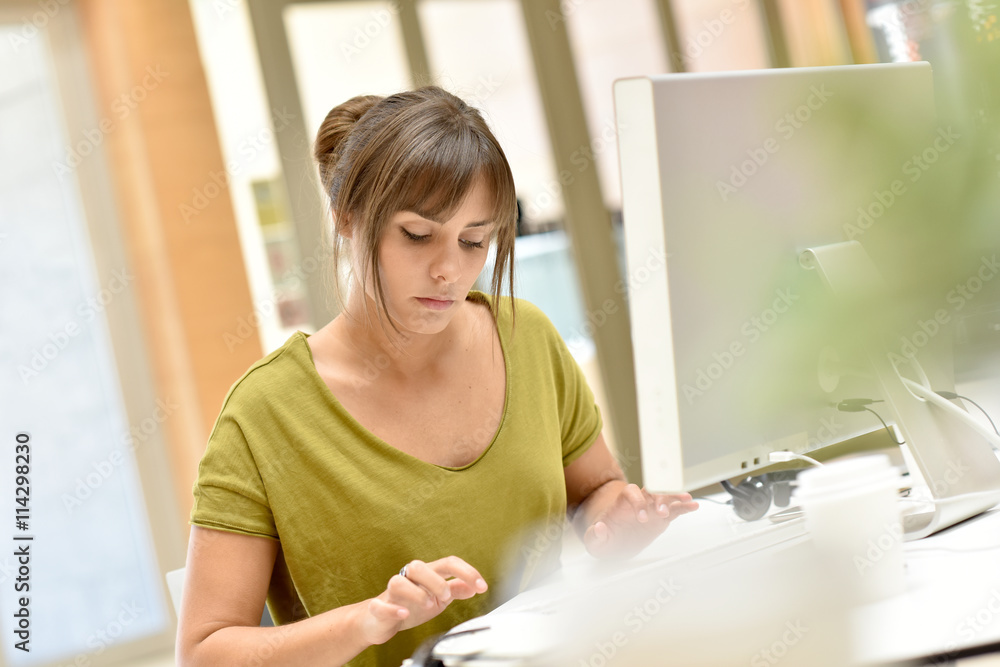 Portrait of office worker in front of desktop Portrait of office worker in front of desktop