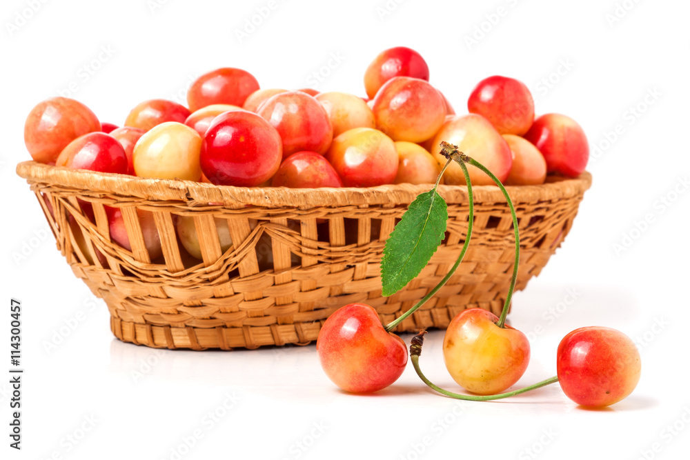 yellow cherries in a wicker basket isolated on white background yellow cherries in a wicker basket isolated on white background