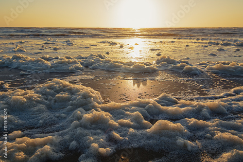 Sea foam on the shore of the North Sea.