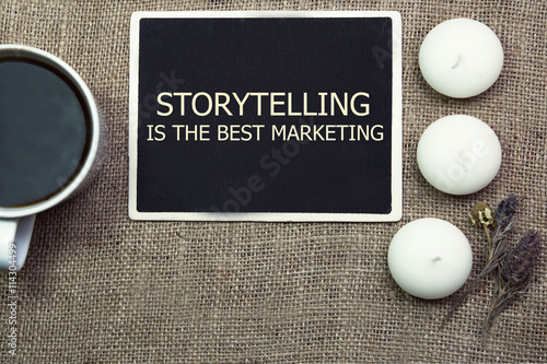 Принти на полотні sentence Storytelling is the best Marketing, written with chalk on a blackboard, on a table with pen and coffee