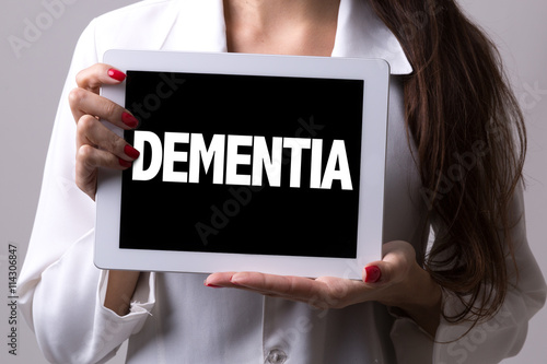 Female doctor holding a tablet with the text: Dementia © gustavofrazao