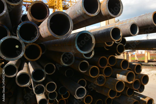 Reinforced tube. Heavy-wall metal pipe. Thick-walled pipe. Stuck of steel pipes. Heavy-gauge pipe bundle in industrial warehouse.