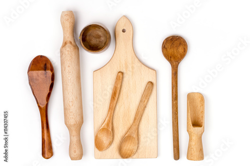 Kitchen wooden cutting board and wooden spoons flat lay