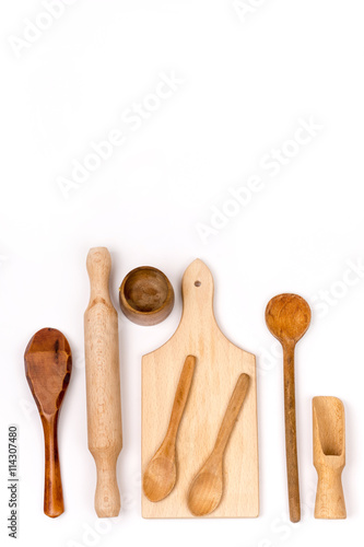 Kitchen wooden cutting board and wooden spoons flat lay