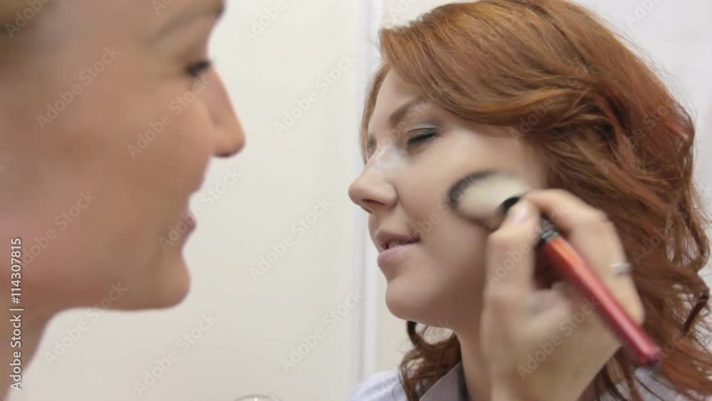 A makeup artist is finishing the makeup A makeup artist is finishing the makeup